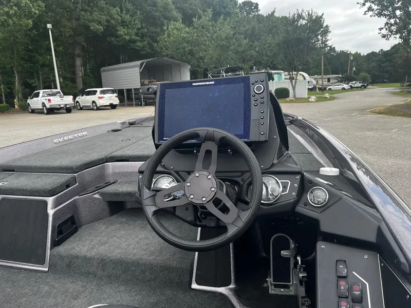 Slide: The Image of 2024 Skeeter ZXR 20 boat dashboard with steering wheel and navigation display. - 26