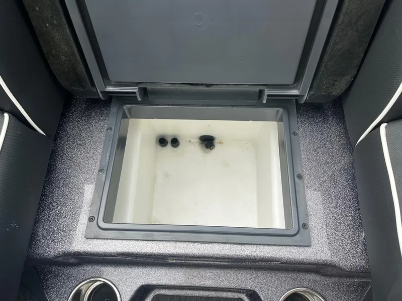 Slide: The Image of 2024 Skeeter ZXR 20 boat storage compartment with open lid, showcasing interior space. - 8