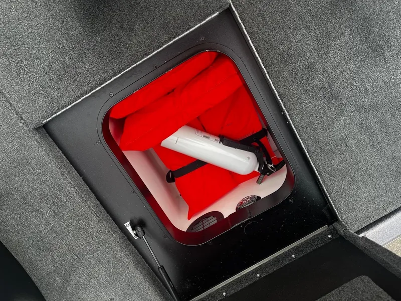 Slide: The Image of Storage compartment in 2024 Skeeter ZXR 20 boat with life jackets and fire extinguisher. - 9