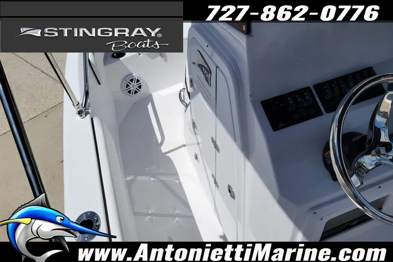 Slide: The Image of 2026 Stingray 173CC boat interior with steering wheel and control panel, featuring marine branding. - 17