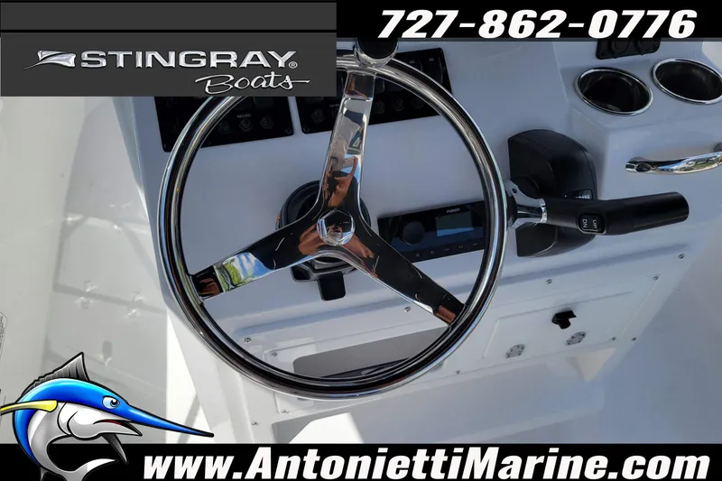 Slide: The Image of Steering wheel of 2026 Stingray 173CC boat, featuring control panel and cup holders. - 21
