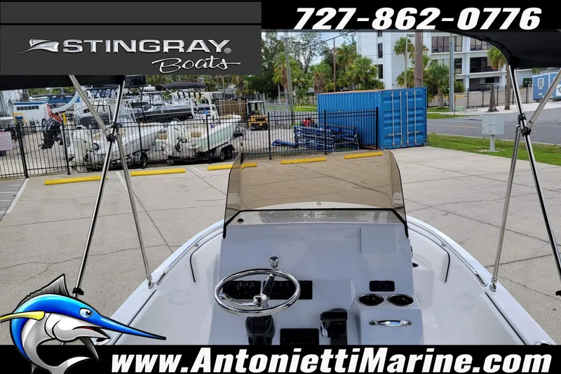 Slide: The Image of 2026 Stingray 173CC boat at Antonietti Marine dealership, featuring console and steering wheel. - 49