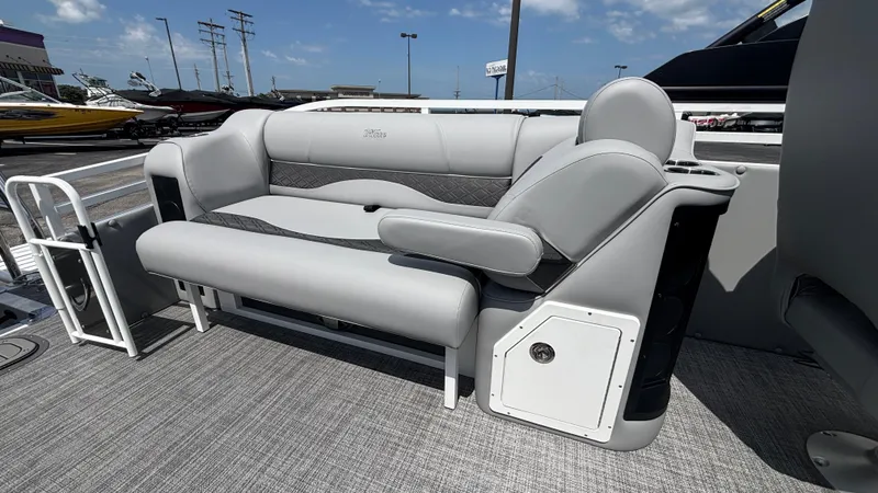 Slide: The Image of 2025 JC Neptoon 25TT Sport boat interior with gray seating and armrest. - 12