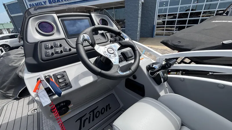 Slide: The Image of 2025 JC Neptoon 25TT Sport boat dashboard with steering wheel and controls. - 21