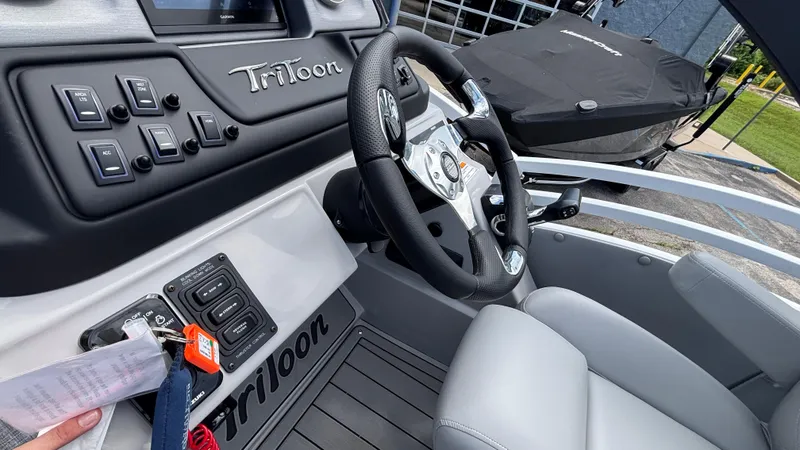 Slide: The Image of Interior of 2025 JC Neptoon 25TT Sport boat with steering wheel and control panel. - 27