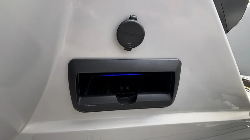 Slide: The Image of 2025 JC Neptoon 25TT Sport wireless charging station on sleek boat console. - 28