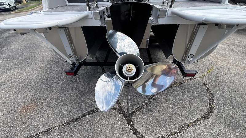 Slide: The Image of 2025 JC Neptoon 25TT Sport boat propeller, rear view on pavement. - 4