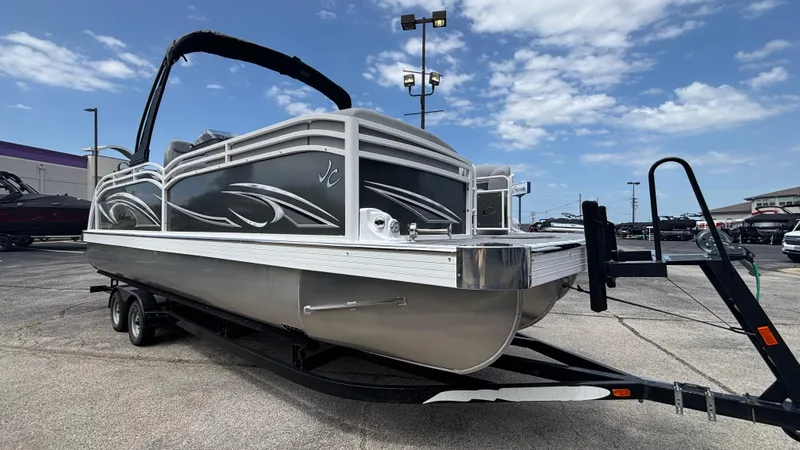 Slide: The Image of 2025 JC Neptoon 25TT Sport pontoon boat on trailer under blue sky. - 40