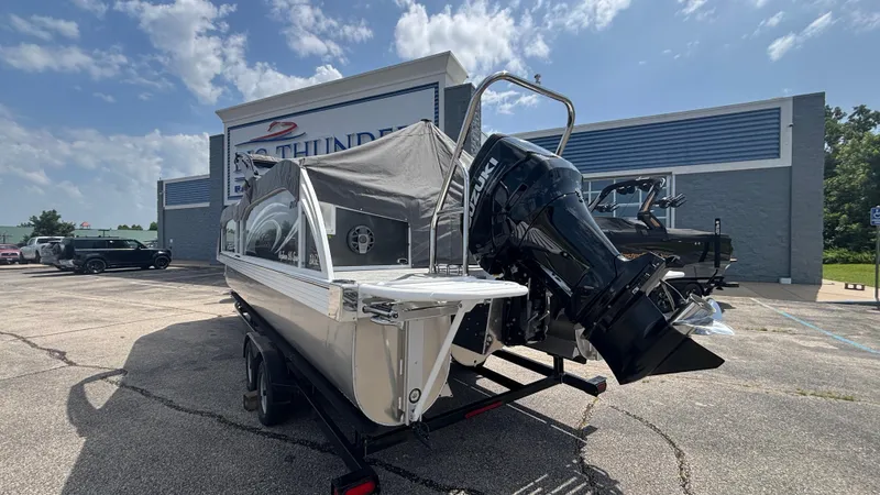 Slide: The Image of 2025 JC Neptoon 25TT Sport boat with Suzuki outboard motor at dealership. - 7