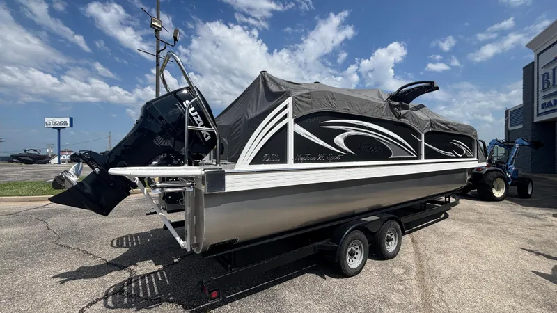 Slide: The Image of 2025 JC Neptoon 25TT Sport pontoon boat on trailer, covered, with Suzuki outboard motor. - 8