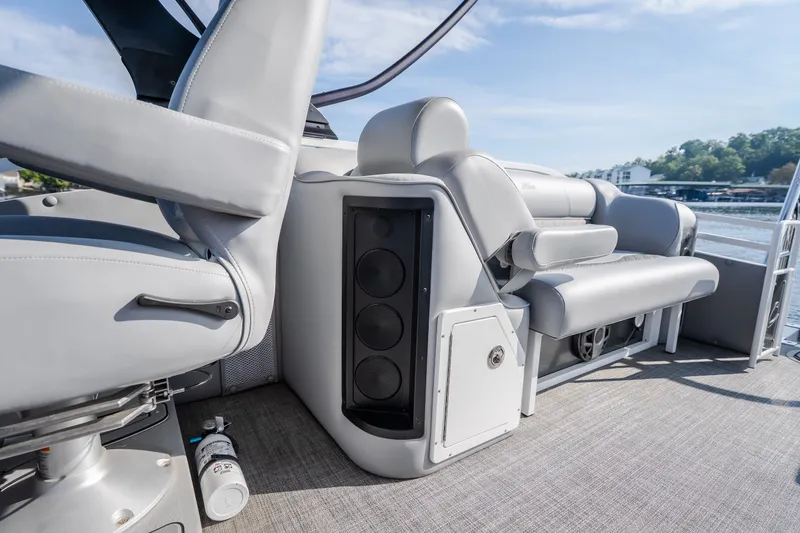 Slide: The Image of Interior of 2025 JC Neptoon 25TT Sport boat with gray seating and speaker system. - 21