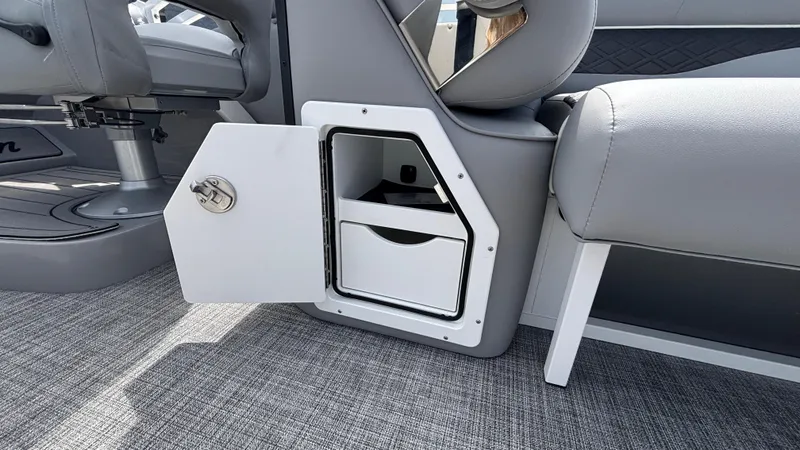 Slide: The Image of 2025 JC Neptoon 25TT Sport boat interior storage compartment with open door. - 19