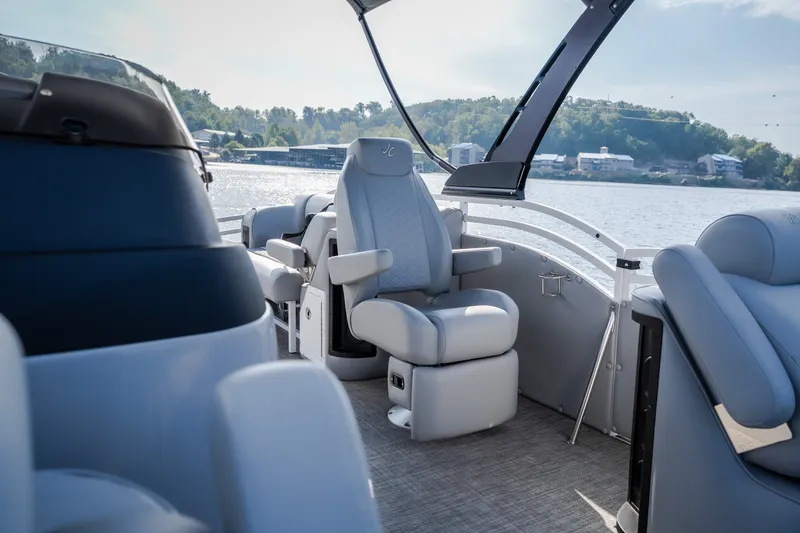 Slide: The Image of Luxury seating on 2025 JC Neptoon 25TT Sport pontoon boat, with scenic lake view. - 18