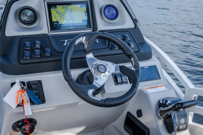 Slide: The Image of Steering console of 2025 JC Neptoon 25TT Sport boat with navigation display. - 8