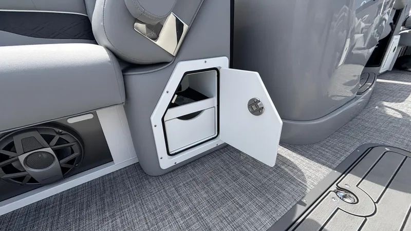 Slide: The Image of 2025 JC Neptoon 25TT Sport boat interior storage compartment with open door. - 38
