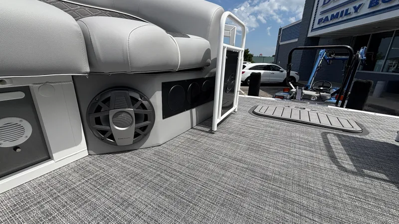 Slide: The Image of 2025 JC Neptoon 25TT Sport boat interior with speakers and gray seating. - 39