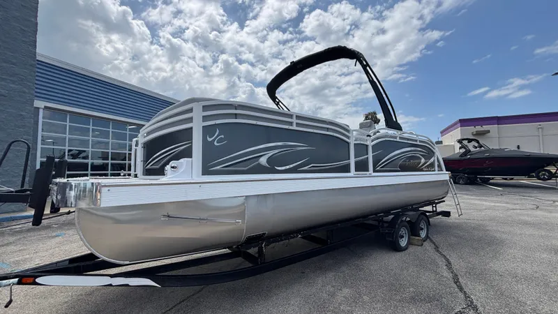 Slide: The Image of 2025 JC Neptoon 25TT Sport pontoon boat on trailer under cloudy sky. - 41
