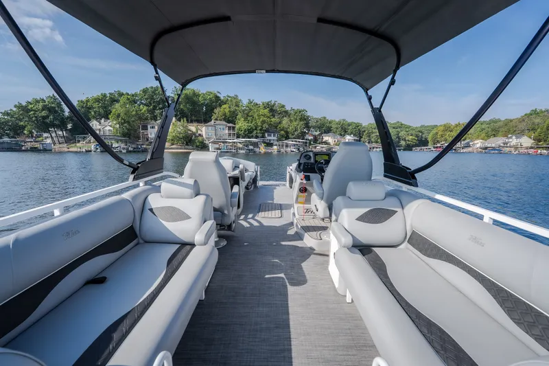 Slide: The Image of 2025 JC Neptoon 25TT Sport pontoon boat with luxurious seating on a serene lake. - 31