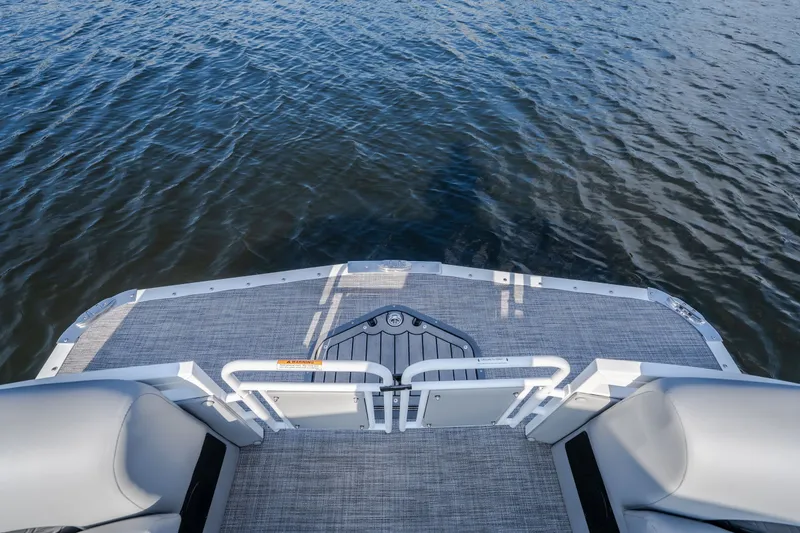 Slide: The Image of 2025 JC Neptoon 25TT Sport boat deck overlooking calm water. - 43