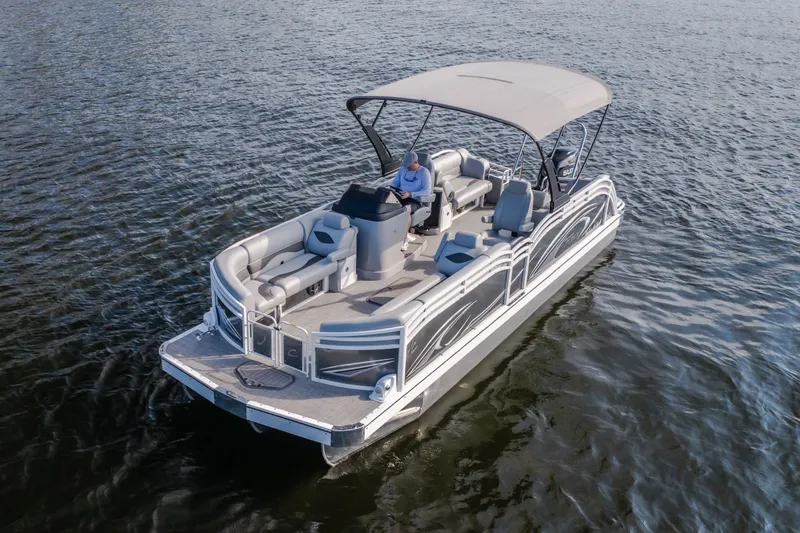 Slide: The Image of 2025 JC Neptoon 25TT Sport pontoon boat cruising on open water. - 58