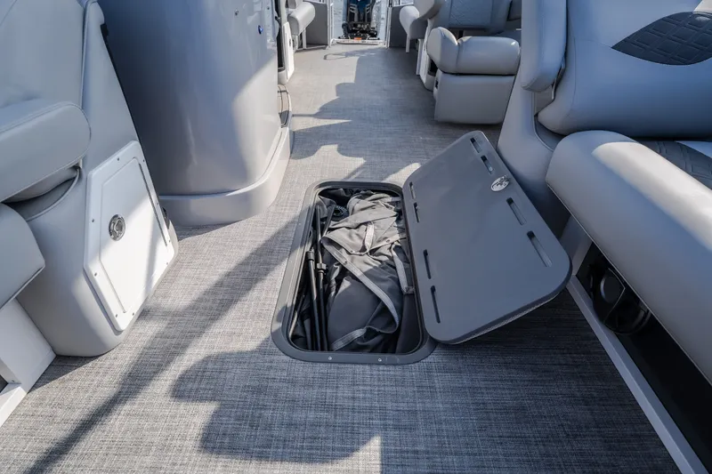 Slide: The Image of 2025 JC Neptoon 25TT Sport boat interior with open storage compartment. - 51
