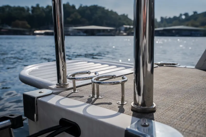 Slide: The Image of 2025 JC Neptoon 25TT Sport boat deck with chrome details on a sunny lake. - 30