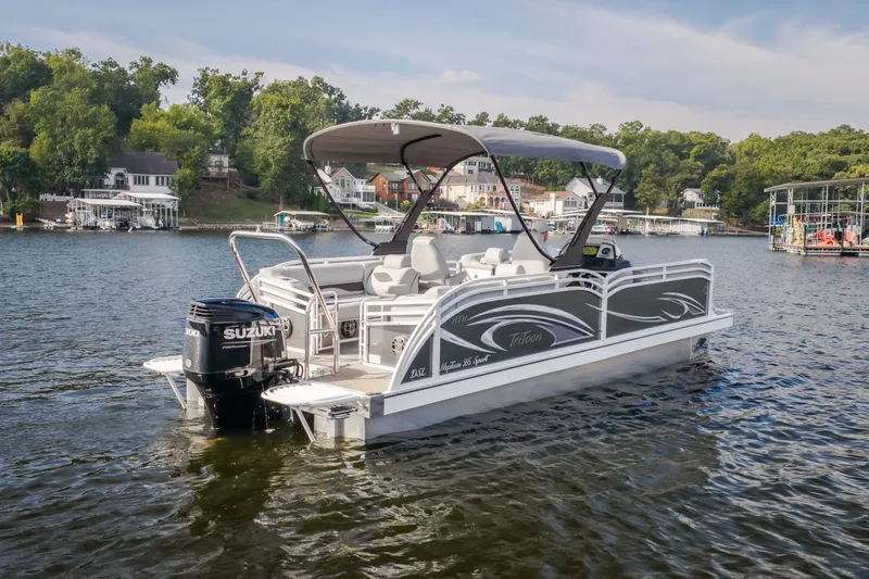 Slide: The Image of 2025 JC Neptoon 25TT Sport pontoon boat on a scenic lake. - 5