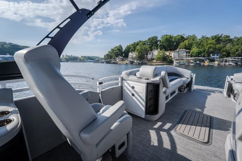 Slide: The Image of Luxurious 2025 JC Neptoon 25TT Sport pontoon boat interior on a scenic lake. - 33