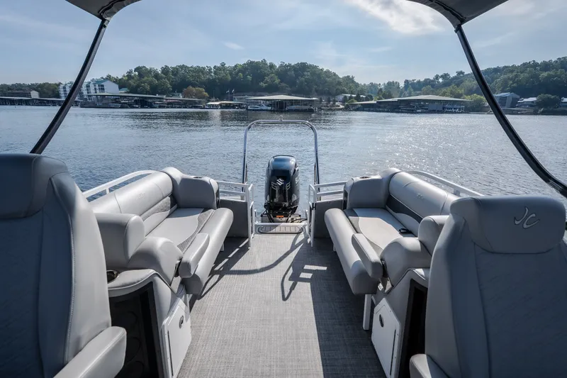 Slide: The Image of 2025 JC Neptoon 25TT Sport pontoon boat interior with lake view and comfortable seating. - 20