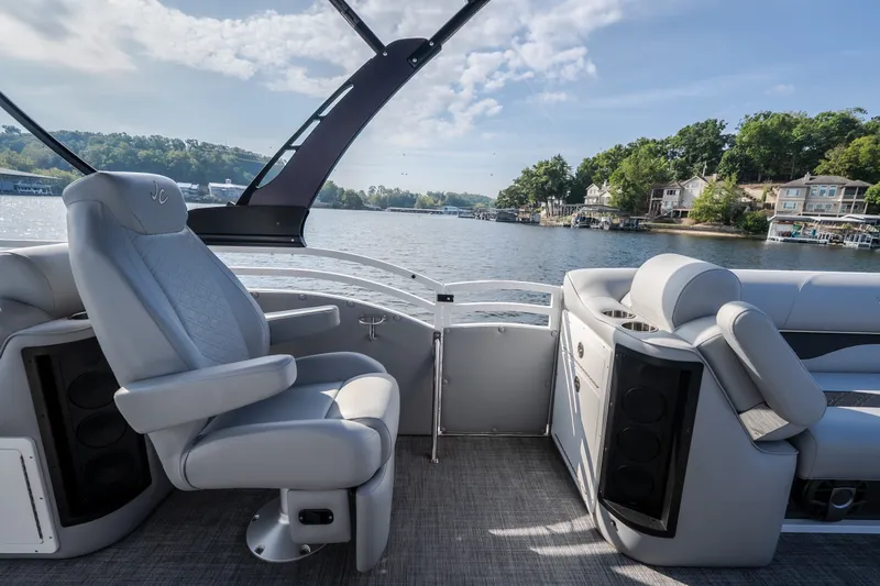Slide: The Image of Luxurious interior of 2025 JC Neptoon 25TT Sport pontoon boat on a scenic lake. - 17
