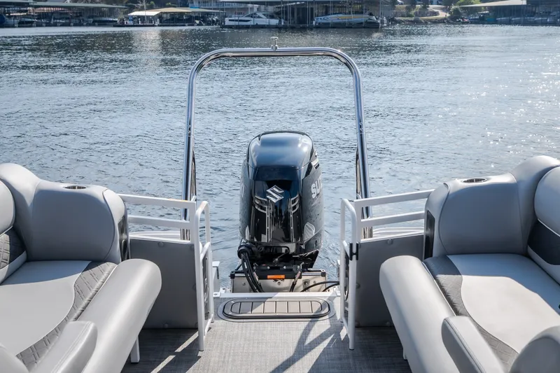 Slide: The Image of 2025 JC Neptoon 25TT Sport pontoon boat with Suzuki outboard motor on a lake. - 23