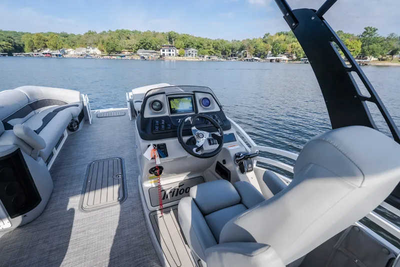 Slide: The Image of 2025 JC Neptoon 25TT Sport pontoon boat interior with modern helm and lake view. - 7