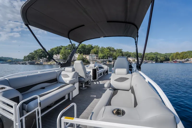 Slide: The Image of 2025 JC Neptoon 25TT Sport pontoon boat with spacious seating on a serene lake. - 28
