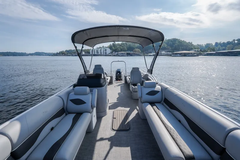 Slide: The Image of 2025 JC Neptoon 25TT Sport pontoon boat on a serene lake. - 48