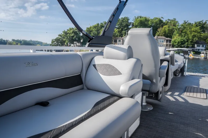 Slide: The Image of 2025 JC Neptoon 25TT Sport pontoon boat interior with luxurious seating and scenic lake view. - 32