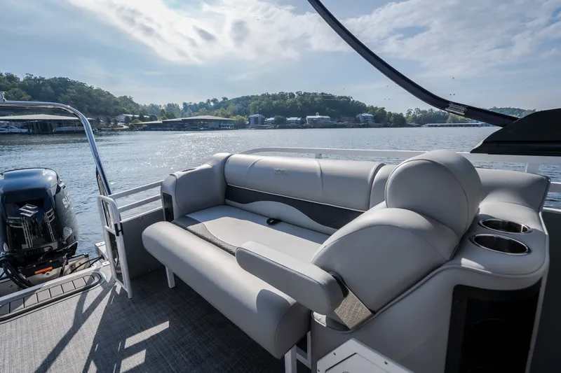 Slide: The Image of 2025 JC Neptoon 25TT Sport pontoon boat with comfortable seating on a scenic lake. - 22
