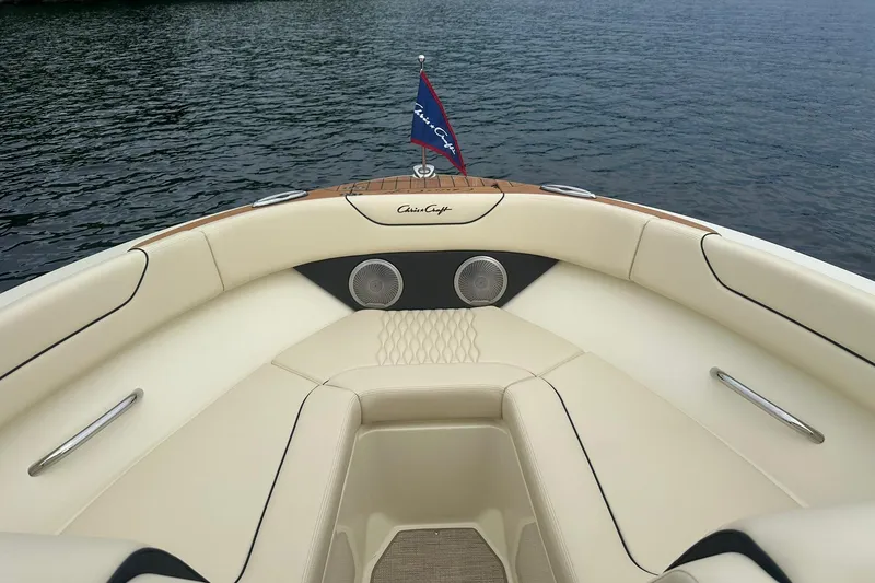 Slide: The Image of 2026 Chris-Craft Sportster 25 boat interior with cream seating and lake view. - 22