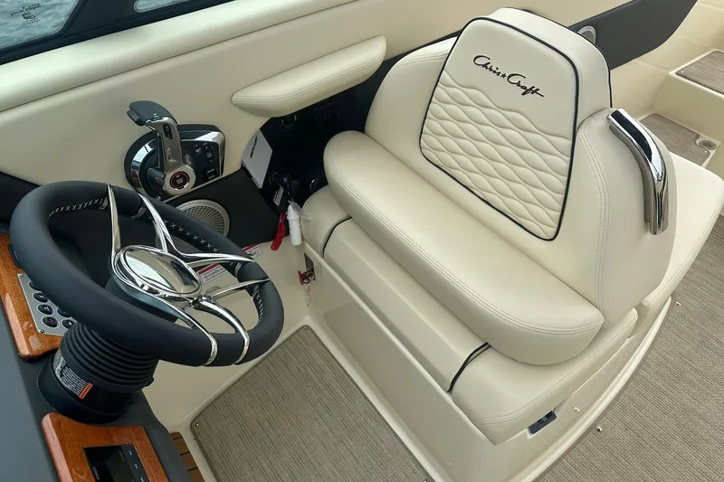Slide: The Image of 2026 Chris-Craft Sportster 25 boat interior with luxurious steering wheel and seating. - 29