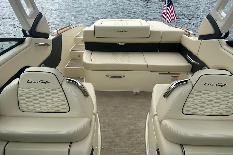 Slide: The Image of 2026 Chris-Craft Sportster 25 boat interior with luxurious seating and American flag. - 28