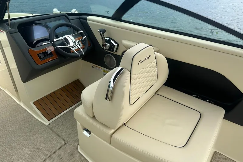 Slide: The Image of 2026 Chris-Craft Sportster 25 interior with luxurious seating and modern dashboard design. - 19