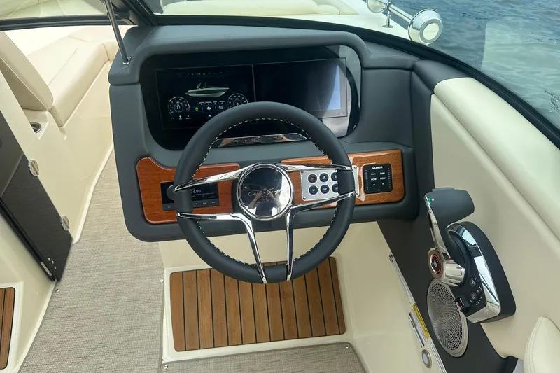 Slide: The Image of 2026 Chris-Craft Sportster 25 dashboard with steering wheel, digital display, and control panel. - 20