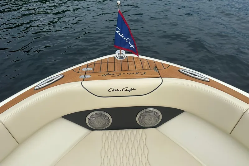 Slide: The Image of 2026 Chris-Craft Sportster 25 boat with elegant wood and leather detailing on water. - 25
