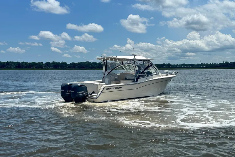 Slide: The Image of 2012 Grady-White Freedom 307 boat cruising on a sunny day with Yamaha engines. - 10
