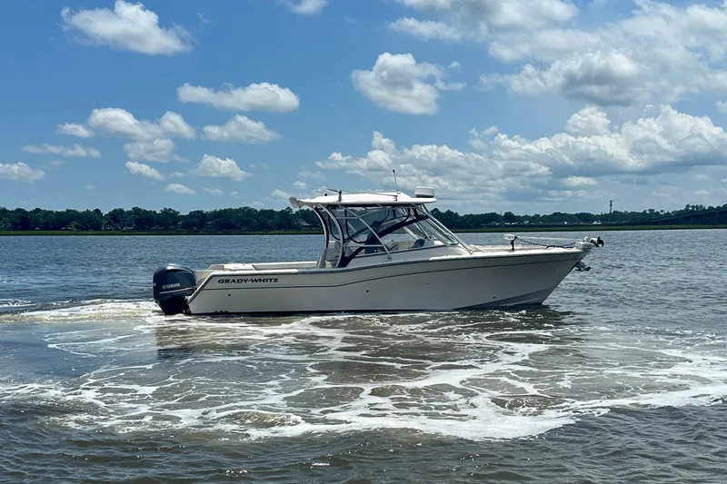 Slide: The Image of 2012 Grady-White Freedom 307 boat cruising on a sunny day with blue skies. - 11