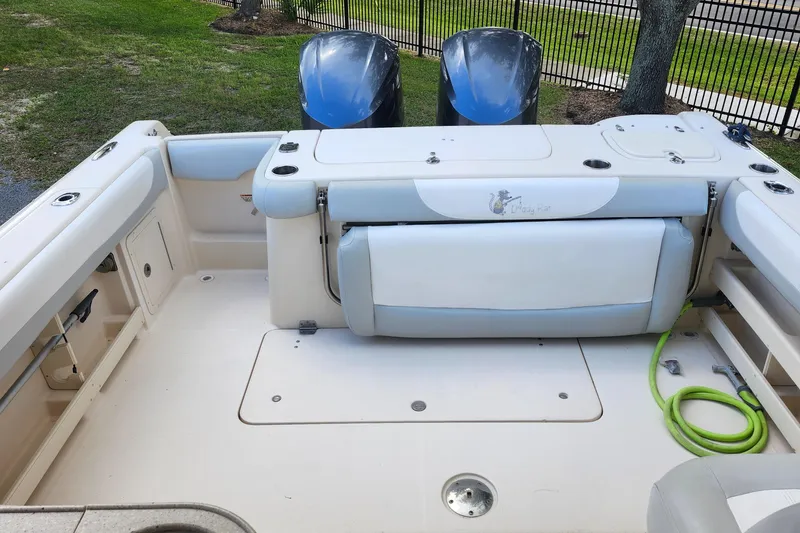 Slide: The Image of 2012 Grady-White Freedom 307 boat interior with seating and twin engines. - 12
