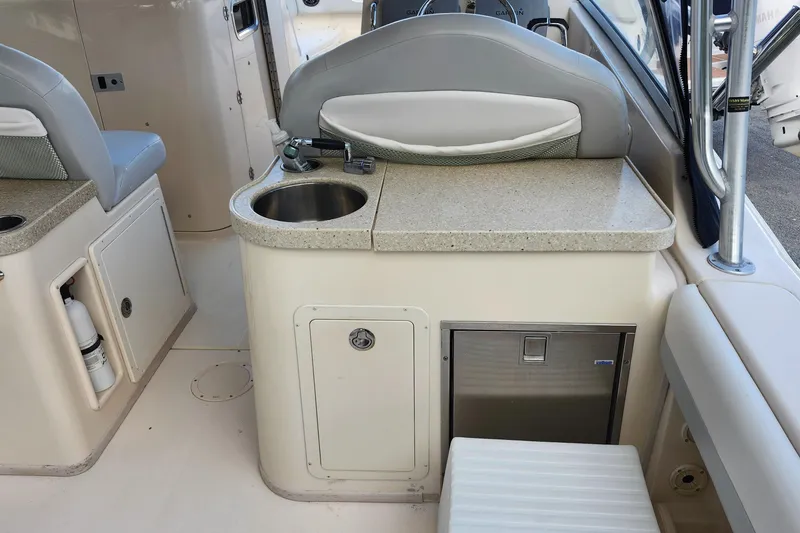 Slide: The Image of 2012 Grady-White Freedom 307 boat interior with sink and seating area. - 14
