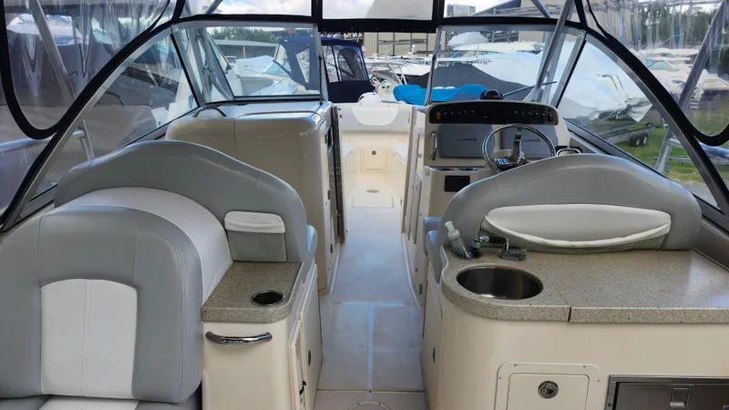 Slide: The Image of 2012 Grady-White Freedom 307 boat interior with helm, seating, and sink. - 15