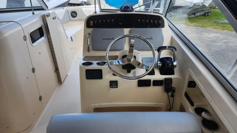 Slide: The Image of 2012 Grady-White Freedom 307 boat cockpit with Garmin navigation system. - 18