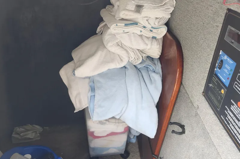 Slide: The Image of Interior of 2012 Grady-White Freedom 307 with stacked towels and control panel. - 20