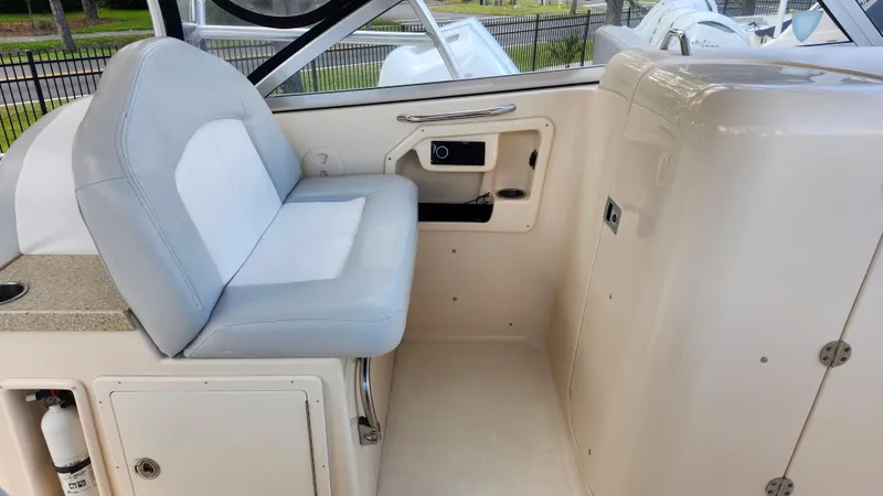 Slide: The Image of 2012 Grady-White Freedom 307 boat interior with seating and storage compartments. - 22
